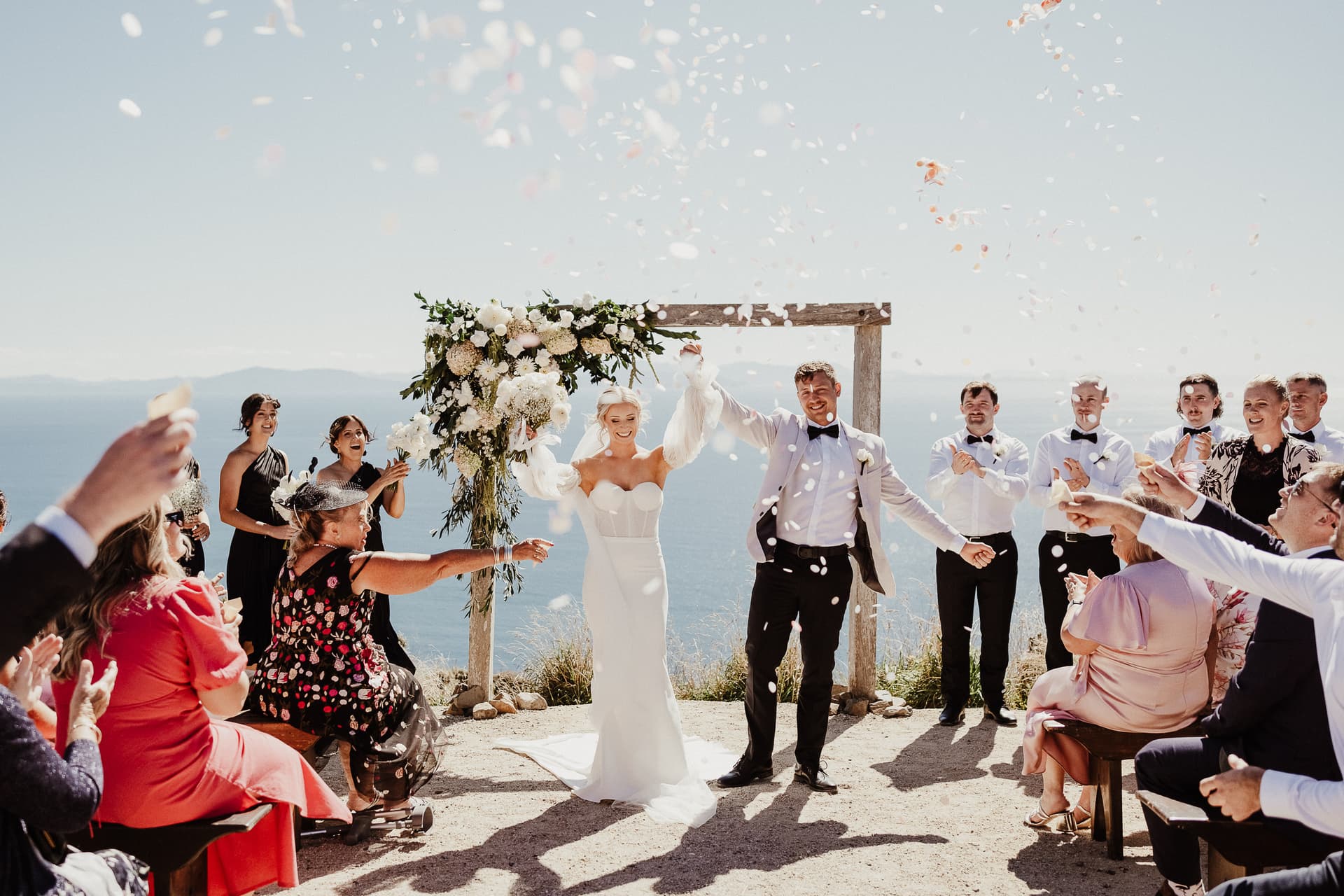 Couple, just married, celebrating with confetti